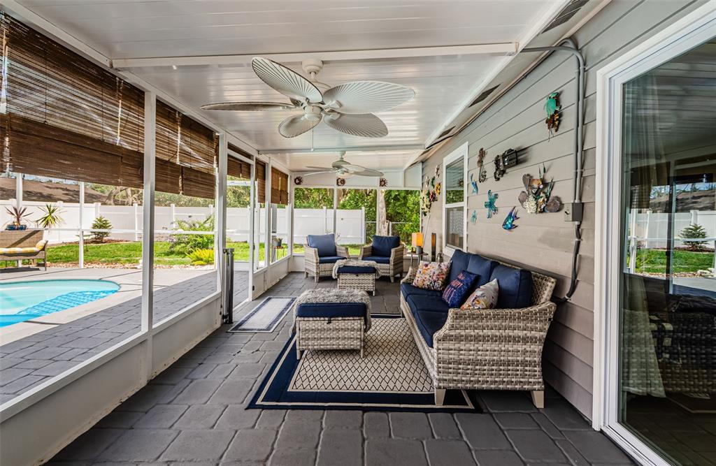 7547 Landmark Drive Spring Hill, FL 34606 - Photo 5 of 34 a balcony with furniture and a wooden floor