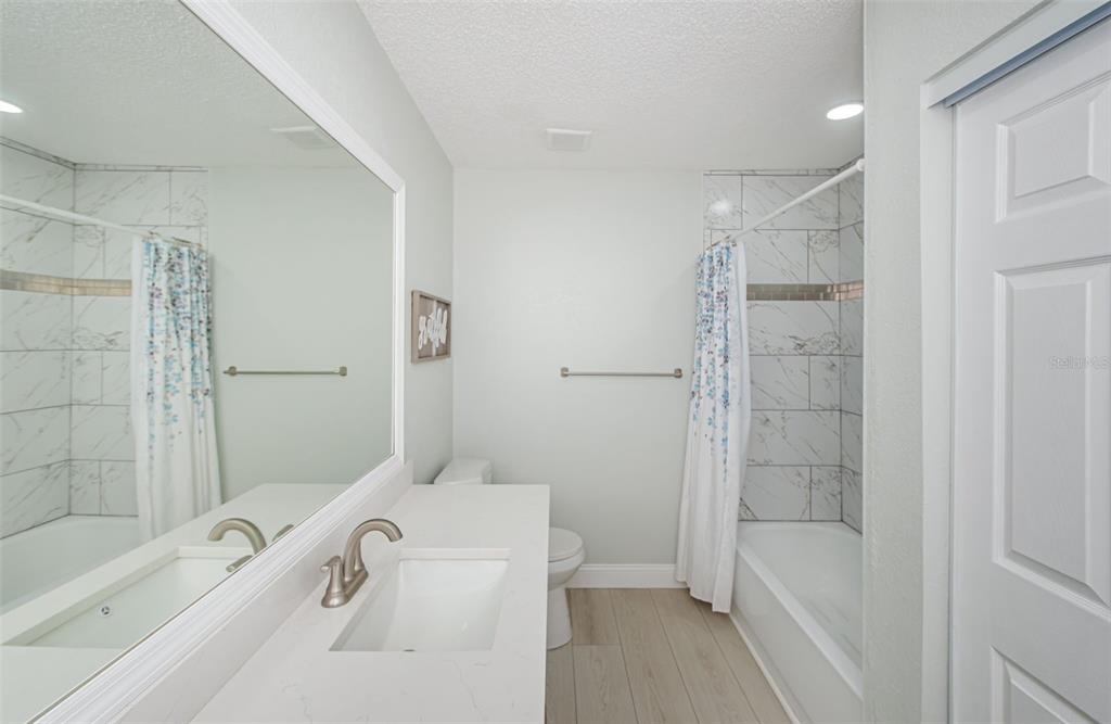 7547 Landmark Drive Spring Hill, FL 34606 - Photo 7 of 34 a bathroom with a tub a sink and a shower