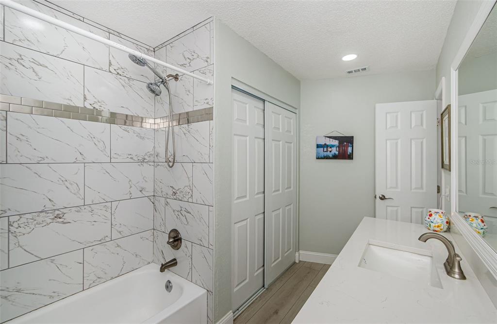 7547 Landmark Drive Spring Hill, FL 34606 - Photo 8 of 34 a bathroom with a tub a sink and a shower