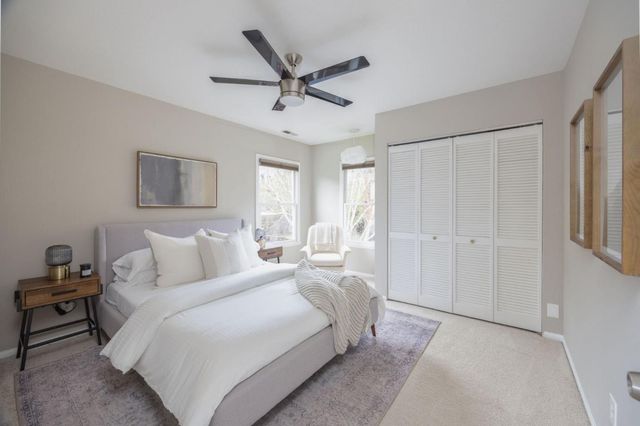 a bedroom with a large bed and a chandelier
