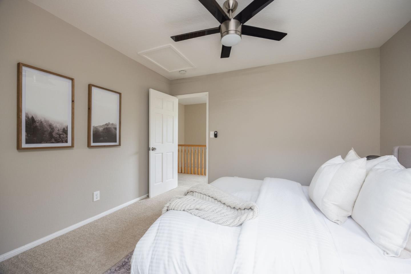 1160 Cedar Street Montara, CA 94037 - Photo 35 of 56 a bedroom with a large bed and a chandelier