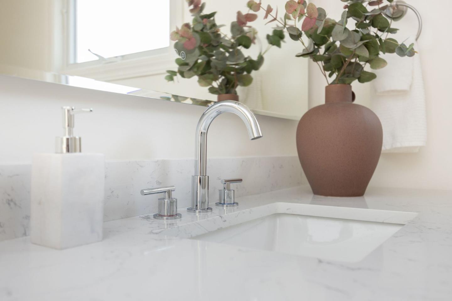 1160 Cedar Street Montara, CA 94037 - Photo 39 of 56 a vase of flowers sitting on a table with a potted plant