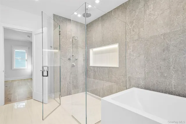 a bathroom with a bathtub and shower