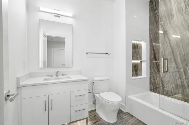 a bathroom with a sink toilet and shower