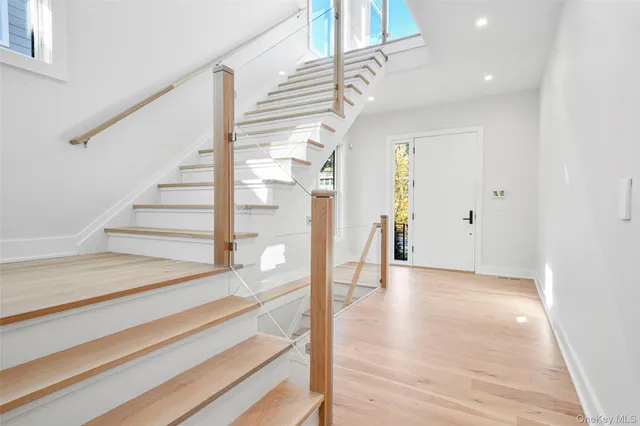 a view of entryway and hall with wooden floor