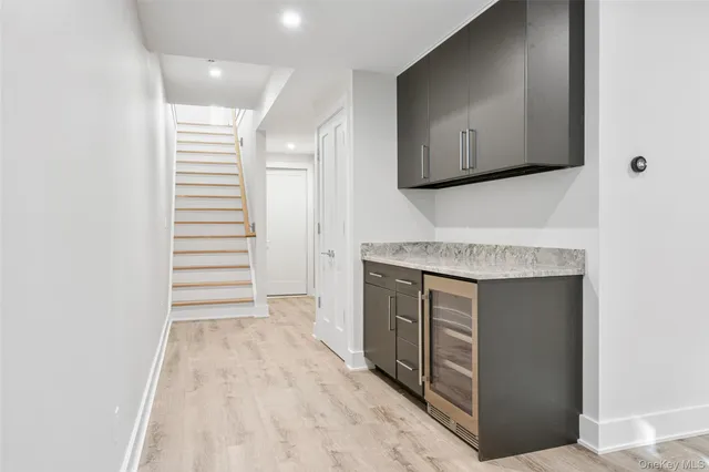 a view of a kitchen with cabinets and wooden floor