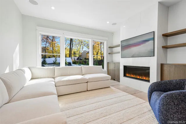 a living room with furniture fireplace and window