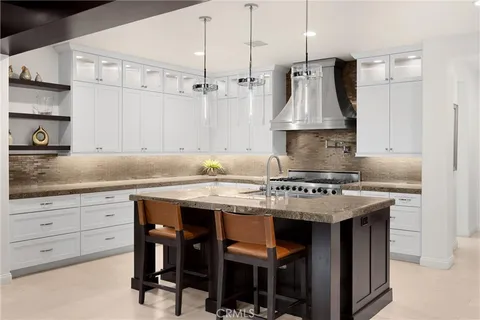 a front view of a house with a yard and potted plants