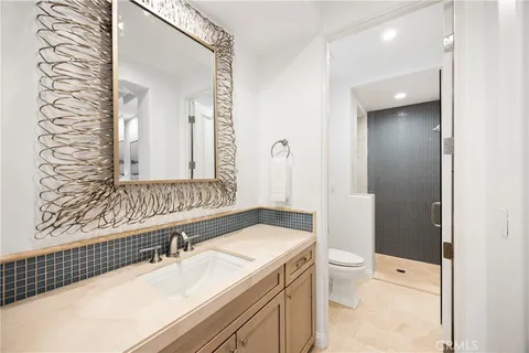 a bedroom with a bed and a flat tv screen on dresser