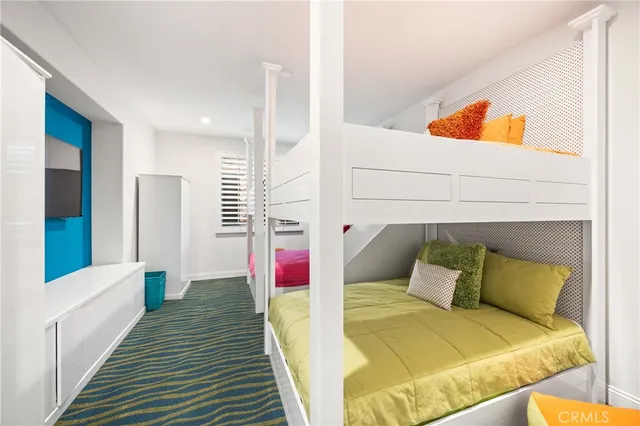 a bedroom with a large bed and a potted plant