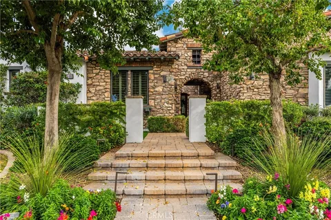 a living room with furniture a chandelier and a fireplace