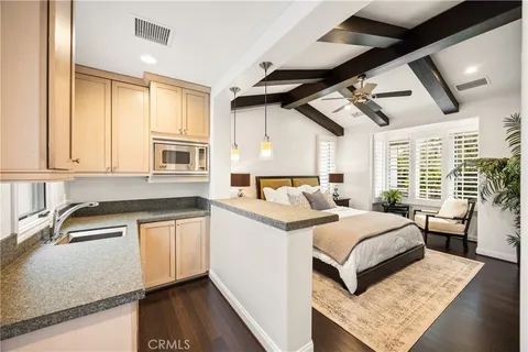 a kitchen with granite countertop a sink and a stove top oven