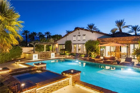 a view of a house with swimming pool and sitting area