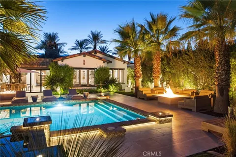 a view of a house with swimming pool and sitting area