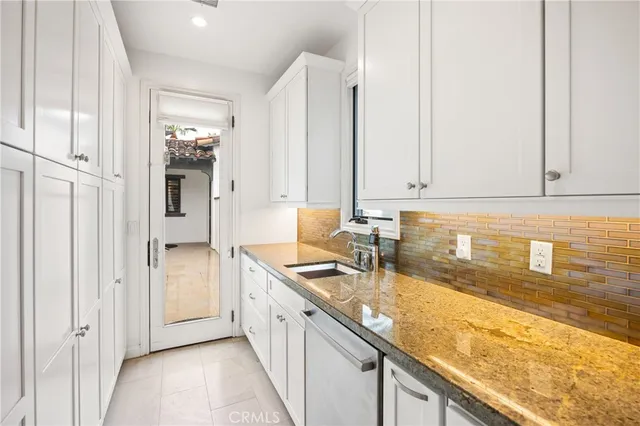 a view of a kitchen with granite countertop cabinets