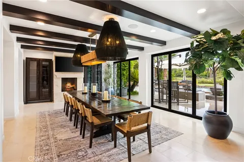 a dining room with furniture potted plants and wooden floor