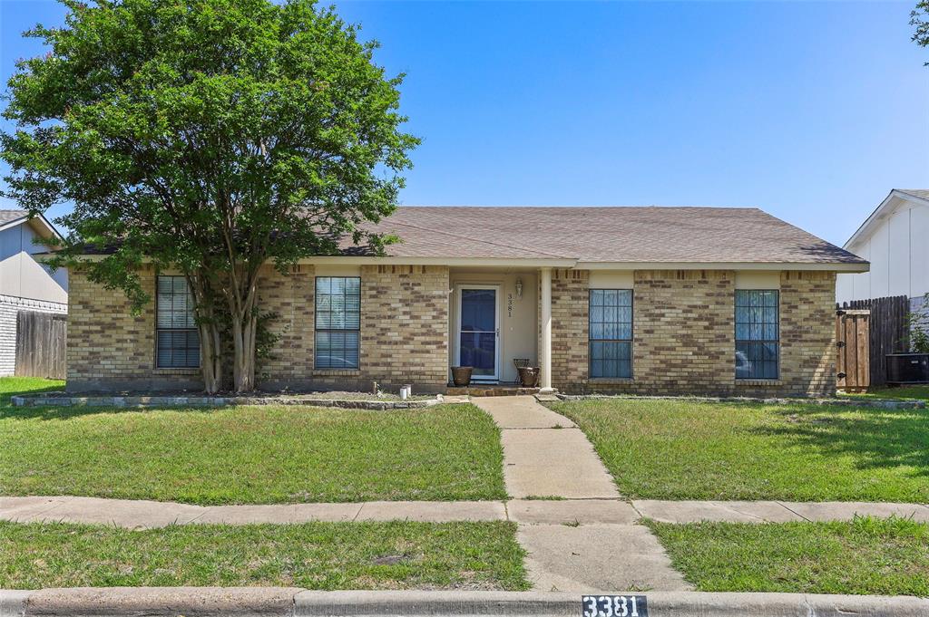 3381 Sam Rayburn Run Carrollton, TX 75007 - Photo 1 of 1 front view of a brick house with a yard