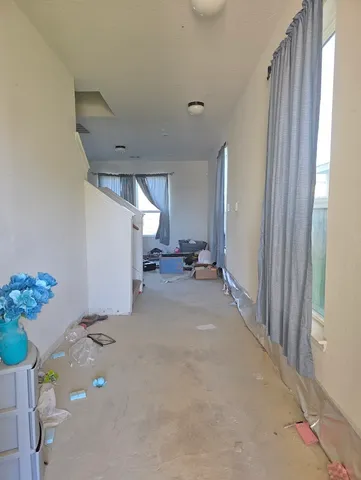 a view of hallway with livingroom and furniture