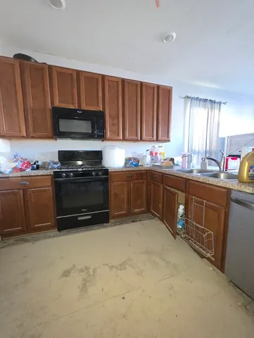 a kitchen with a sink a stove and cabinets