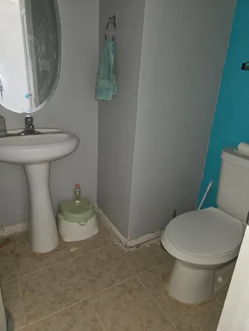 a bathroom with a toilet sink and mirror