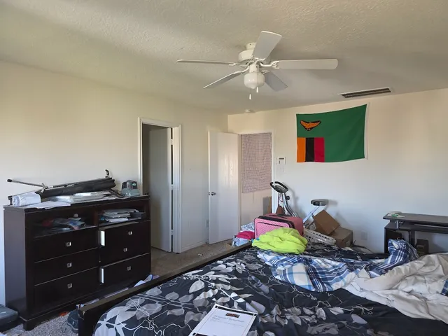 a bed room with a bed and a mirror