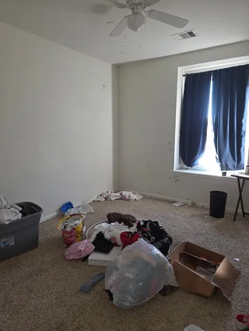 a bedroom with bed and a chandelier