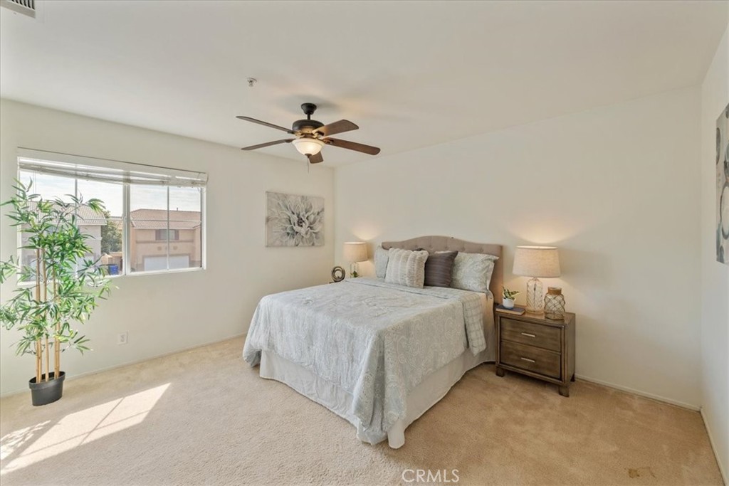 10562 Mustang Circle Montclair, CA 91763 - Photo 12 of 19 a bedroom with a bed and a potted plant