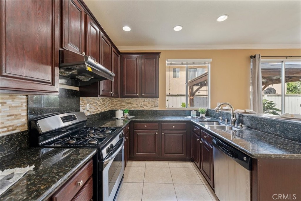 10562 Mustang Circle Montclair, CA 91763 - Photo 6 of 19 a kitchen with stainless steel appliances granite countertop a sink stove and cabinets
