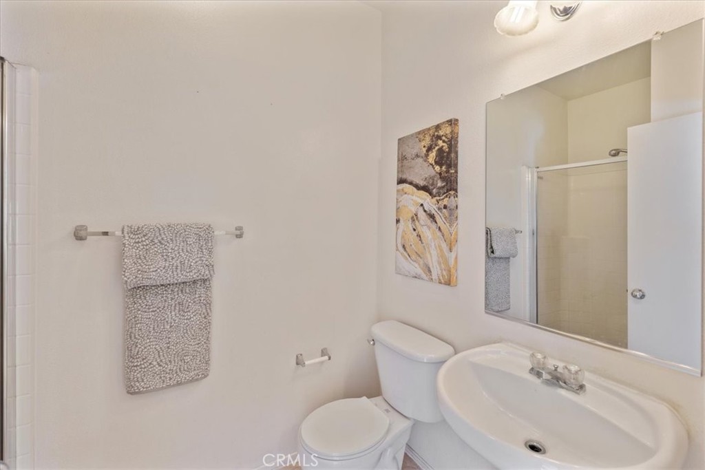 10562 Mustang Circle Montclair, CA 91763 - Photo 8 of 19 a bathroom with a toilet sink and mirror