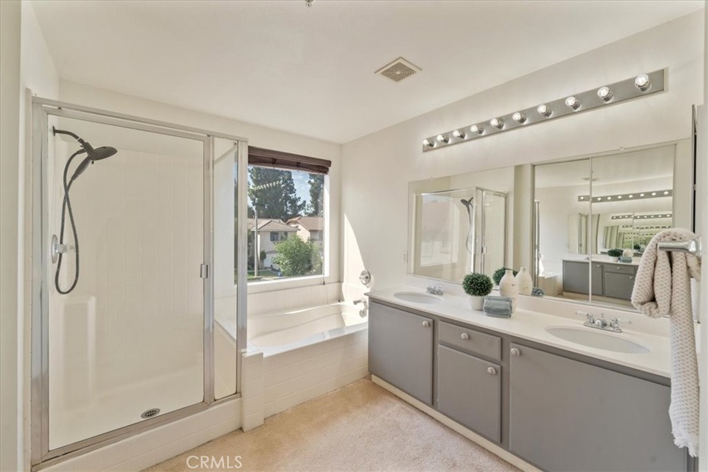 10562 Mustang Circle Montclair, CA 91763 - Photo 10 of 19 a bathroom with a double vanity sink window and a mirror