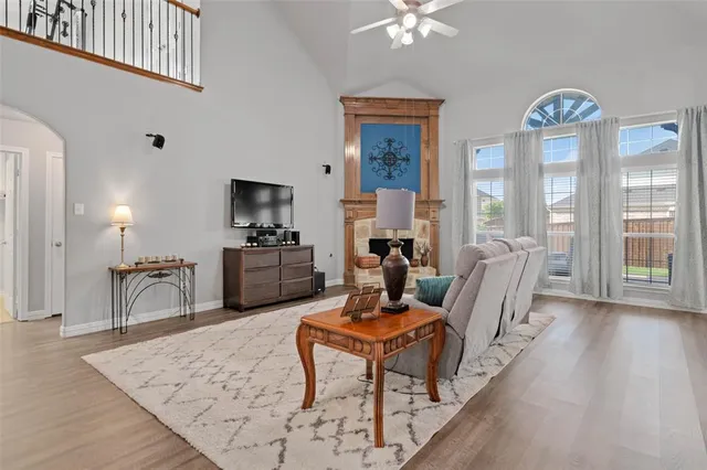 a living room with furniture a large window and a table