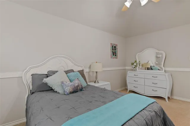 a bedroom with a bed and a dresser