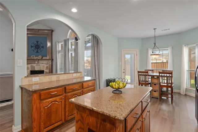 a view of a kitchen area kitchen island dining table wooden floor and kitchen view