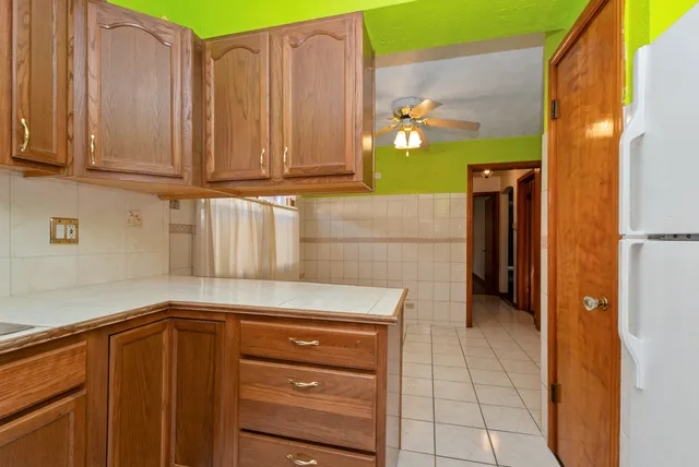 a kitchen with a refrigerator and cabinets