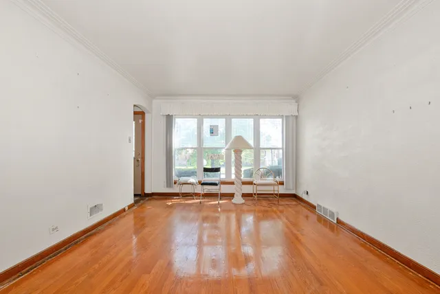 a view of a room with wooden floor and glass door
