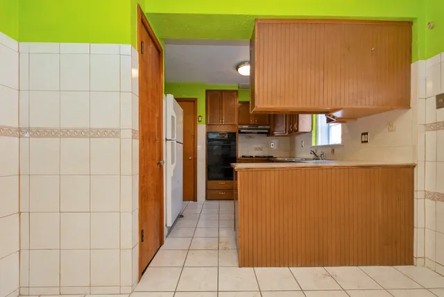 a kitchen with stainless steel appliances a refrigerator and a stove