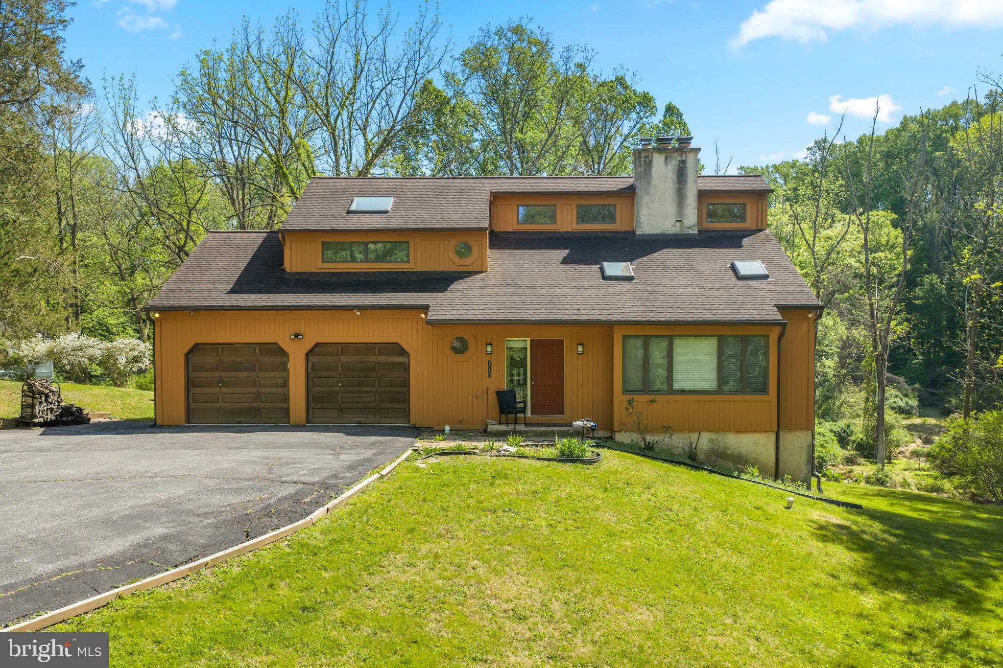 1680 East Street Road Kennett Square, PA 19348 - Photo 3 of 30 a front view of a house with a yard and garage