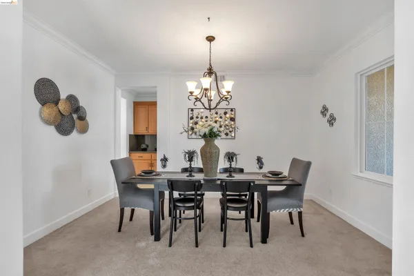a view of a dining room with furniture and chandelier