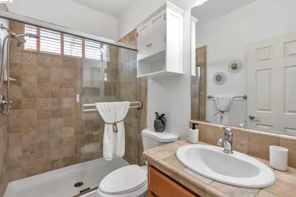 a kitchen with stainless steel appliances granite countertop a sink a stove and refrigerator