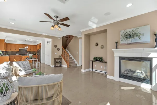 a kitchen with stainless steel appliances granite countertop a stove a sink dishwasher a refrigerator and white cabinets with wooden floor
