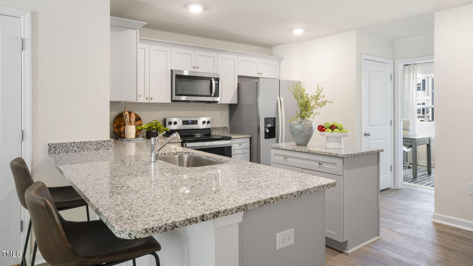 8748 Asher Gray Way Raleigh, NC 27616 - Photo 11 of 33 a kitchen with stainless steel appliances granite countertop a kitchen island hardwood floor and a sink