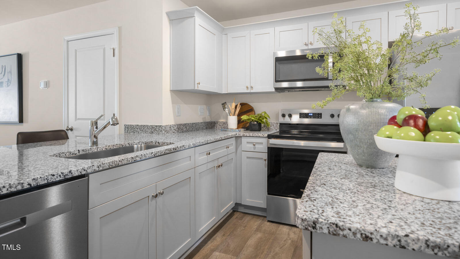 8748 Asher Gray Way Raleigh, NC 27616 - Photo 5 of 33 a kitchen with stainless steel appliances granite countertop a sink stove and cabinets
