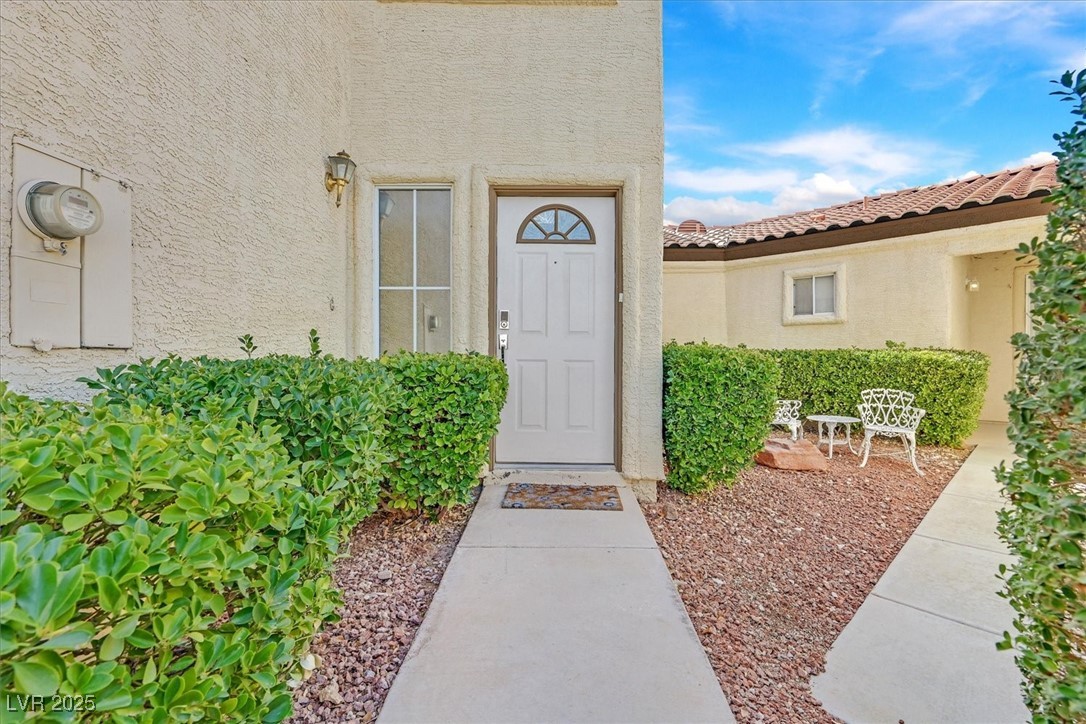5421 Painted Mirage Road Las Vegas, NV 89149 - Photo 2 of 35 Property entrance featuring a tiled roof and stucco siding