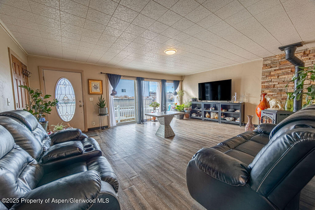 298 Middle Street Rangely, CO 81648 - Photo 17 of 75 a living room with furniture a flat screen tv and a fireplace