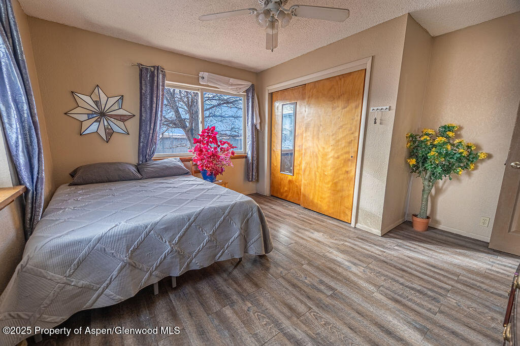 298 Middle Street Rangely, CO 81648 - Photo 25 of 75 a bedroom with a bed and a potted plant