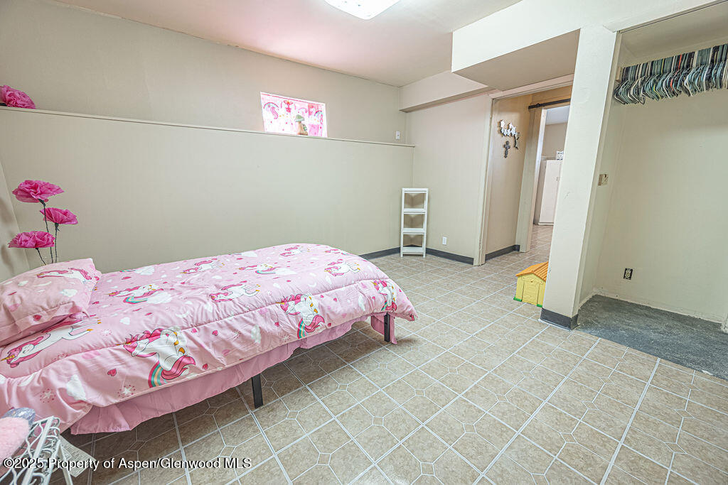 298 Middle Street Rangely, CO 81648 - Photo 33 of 75 a bedroom with a bed and a window