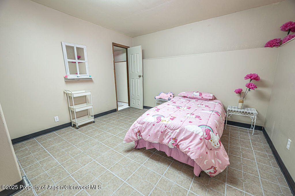 298 Middle Street Rangely, CO 81648 - Photo 34 of 75 a bedroom with a bed and a window