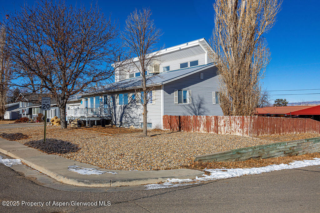 298 Middle Street Rangely, CO 81648 - Photo 4 of 75 a view of a white house with a large tree