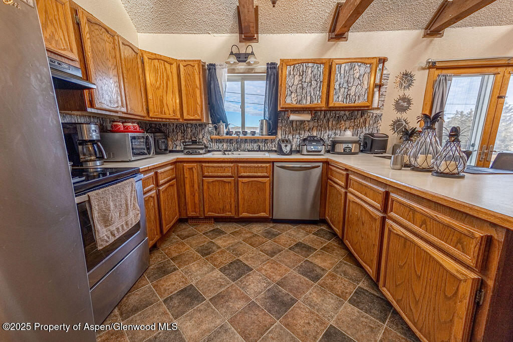 298 Middle Street Rangely, CO 81648 - Photo 8 of 75 a kitchen with stainless steel appliances granite countertop a sink and cabinets