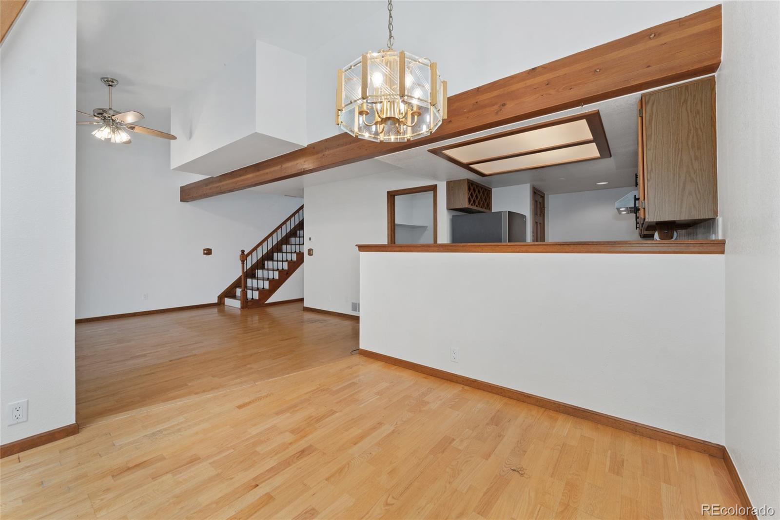 92 Ward Court Lakewood, CO 80228 - Photo 11 of 37 a view of a livingroom with wooden floor and stairs